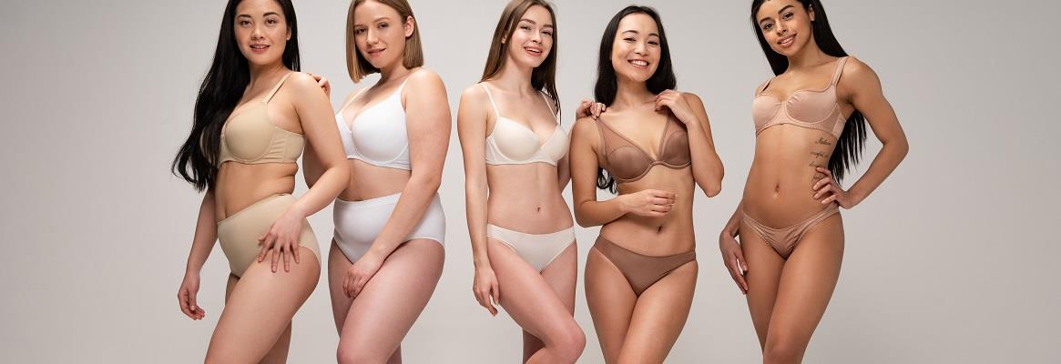 Five cheerful multicultural women in underwear